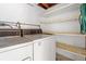 Laundry room with washer, dryer, and storage shelves at 18053 2Nd E St, Redington Shores, FL 33708