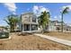 Two-story Craftsman style home with gray siding, walkway, and landscaping at 3839 71St N St, St Petersburg, FL 33709