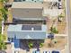 Aerial view of two houses with solar panels, paved driveways, and landscaping at 3839 71St N St, St Petersburg, FL 33709