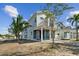 Two-story home with a front porch, landscaping, and walkway at 3839 71St N St, St Petersburg, FL 33709
