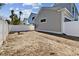 Unlandscaped side yard with white vinyl fence at 3839 71St N St, St Petersburg, FL 33709