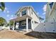 Two-story home with gray and blue siding, covered porch, and white fence at 3839 71St N St, St Petersburg, FL 33709