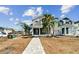 Two-story home with gray siding, walkway, and landscaping at 3839 71St N St, St Petersburg, FL 33709