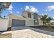 Two-car garage with gray door and paver driveway at 3839 71St N St, St Petersburg, FL 33709