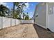 Large backyard with unlandscaped area and white fence at 3839 71St N St, St Petersburg, FL 33709