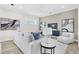 Spacious living room with light gray sofa and armchairs, and a neutral color palette at 3839 71St N St, St Petersburg, FL 33709
