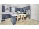 Modern kitchen island with white quartz countertop and navy blue cabinetry at 3839 71St N St, St Petersburg, FL 33709