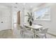 Bright dining area with light wood table and gray chairs near entryway at 3839 71St N St, St Petersburg, FL 33709