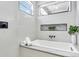 Modern bathroom with soaking tub, stylish tile, and black accents at 3839 71St N St, St Petersburg, FL 33709