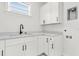 Clean laundry room with white cabinets and a modern sink at 3839 71St N St, St Petersburg, FL 33709