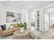 Relaxing sitting area with a leather sofa and a view into a bedroom at 3839 71St N St, St Petersburg, FL 33709