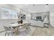 Light and airy dining area with a large wooden table and comfortable gray chairs at 3839 71St N St, St Petersburg, FL 33709