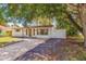 Charming house nestled amongst lush greenery, showcasing curb appeal at 135 Se Monroe N Cir, St Petersburg, FL 33703