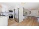 Open concept kitchen with stainless steel appliances and light wood floors at 135 Se Monroe N Cir, St Petersburg, FL 33703
