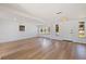 Open living area with light wood flooring and large windows at 135 Se Monroe N Cir, St Petersburg, FL 33703