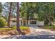 Newly renovated home with a spacious front yard and driveway at 135 Se Monroe N Cir, St Petersburg, FL 33703