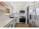 Updated kitchen featuring stainless steel appliances and light wood flooring at 135 Se Monroe N Cir, St Petersburg, FL 33703