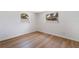 Spacious bedroom with wood-look flooring and large window at 135 Se Monroe N Cir, St Petersburg, FL 33703