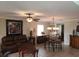 Living room with tiled floors, leather sofas, and a dining area at 2719 Mingo Dr, Land O Lakes, FL 34638