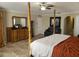 Main bedroom with a post bed, dresser, and sitting area at 2719 Mingo Dr, Land O Lakes, FL 34638