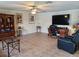 Spacious living room featuring hardwood floors, large TV, and ample seating at 2719 Mingo Dr, Land O Lakes, FL 34638