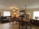 Living room with tiled floors, leather sofas, and a dining area at 2719 Mingo Dr, Land O Lakes, FL 34638