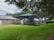 Community playground with shaded structure and play equipment at 2719 Mingo Dr, Land O Lakes, FL 34638