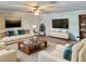 Living room with light beige sofas and a large TV at 2719 Mingo Dr, Land O Lakes, FL 34638