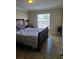 Well-lit bedroom with a double bed and nightstand at 2719 Mingo Dr, Land O Lakes, FL 34638