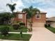 Two-story house with palm trees and a landscaped yard at 2719 Mingo Dr, Land O Lakes, FL 34638