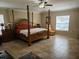 Large main bedroom with a post bed and plenty of space at 2719 Mingo Dr, Land O Lakes, FL 34638