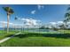 Community tennis courts surrounded by lush landscaping and water views at 9 Haig Pl # 312, Dunedin, FL 34698