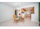 Dining area with glass-top table and kitchen partially visible at 8693 Bardmoor Blvd # 202B, Seminole, FL 33777