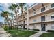 Two-story building with balconies, landscaping, and palm trees at 8693 Bardmoor Blvd # 202B, Seminole, FL 33777