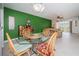 Dining area with glass top table and four chairs, green accent wall at 8693 Bardmoor Blvd # 202B, Seminole, FL 33777