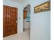 Light and bright entryway with wood door and view into adjacent space at 8693 Bardmoor Blvd # 202B, Seminole, FL 33777