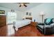 Bright bedroom with wood floors and ceiling fan at 8693 Bardmoor Blvd # 202B, Seminole, FL 33777