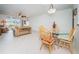 Dining area with glass table and four chairs, overlooking the living room at 8693 Bardmoor Blvd # 202B, Seminole, FL 33777