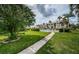 Community pool with a surrounding grassy area and walkway at 8693 Bardmoor Blvd # 202B, Seminole, FL 33777