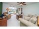 Living room with balcony access and view of pool area at 8693 Bardmoor Blvd # 202B, Seminole, FL 33777