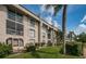 Two-story building with balconies, lush landscaping, and a grassy area at 8693 Bardmoor Blvd # 202B, Seminole, FL 33777