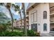 Building exterior with double entry doors and palm trees at 8693 Bardmoor Blvd # 202B, Seminole, FL 33777
