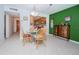 Dining area with glass table and kitchen view at 8693 Bardmoor Blvd # 202B, Seminole, FL 33777