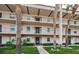 Two-story condo building with palm trees and landscaping at 8693 Bardmoor Blvd # 202B, Seminole, FL 33777