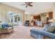 Open floor plan Gathering room with kitchen views and sliding glass doors at 22531 Eagles Watch Dr, Land O Lakes, FL 34639