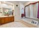 Bathroom with a soaking tub and double vanity at 22531 Eagles Watch Dr, Land O Lakes, FL 34639