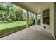 Covered patio overlooking a large backyard with lush landscaping at 22531 Eagles Watch Dr, Land O Lakes, FL 34639