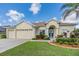 House exterior with three-car garage and manicured landscaping at 22531 Eagles Watch Dr, Land O Lakes, FL 34639