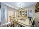 Dining room with light wood table and chairs, hutch, and hardwood floors at 6262 142Nd N Ave # 710, Clearwater, FL 33760