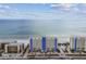 Expansive aerial view of condo complex with beach access and beautiful blue ocean views on a sunny day at 14950 Gulf Blvd # 404, Madeira Beach, FL 33708